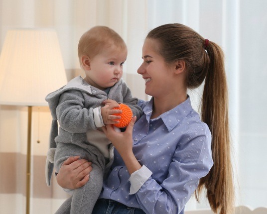 Mother holding child at dental office