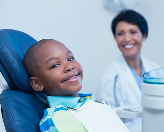 Child getting a dental checkup in Hamilton