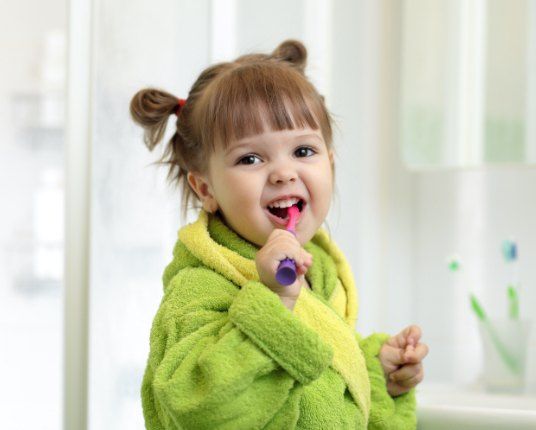 Young girl brushing teeth