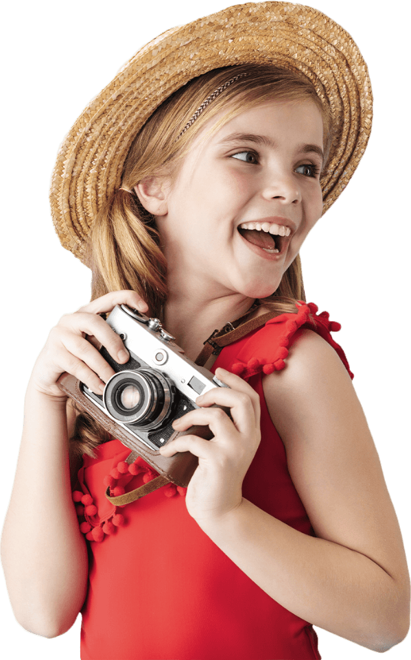 Smiling girl holding a camera