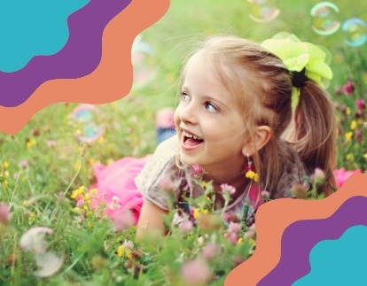 little girl smiling in a field of flowers