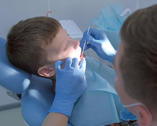 Child receiving fluoride treatment