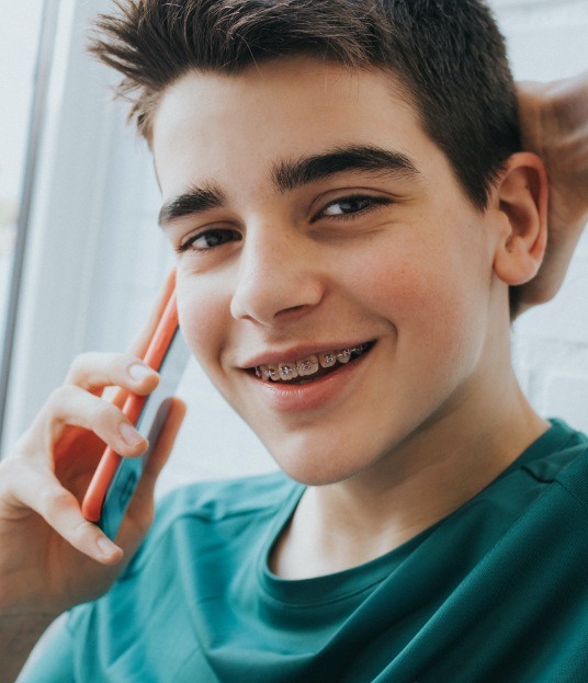 Teen with orthodontics smiling