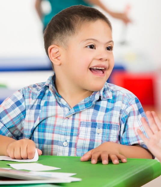 Young child smiling after dentistry for children with special needs