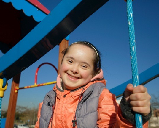 Young girl smiling after dentistry for patients with special needs