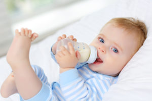 Baby with bottle in need of frenectomy in Hamilton