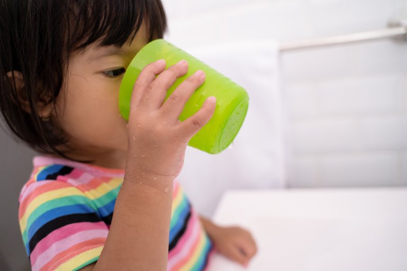 Child drinking water with fluoride in it