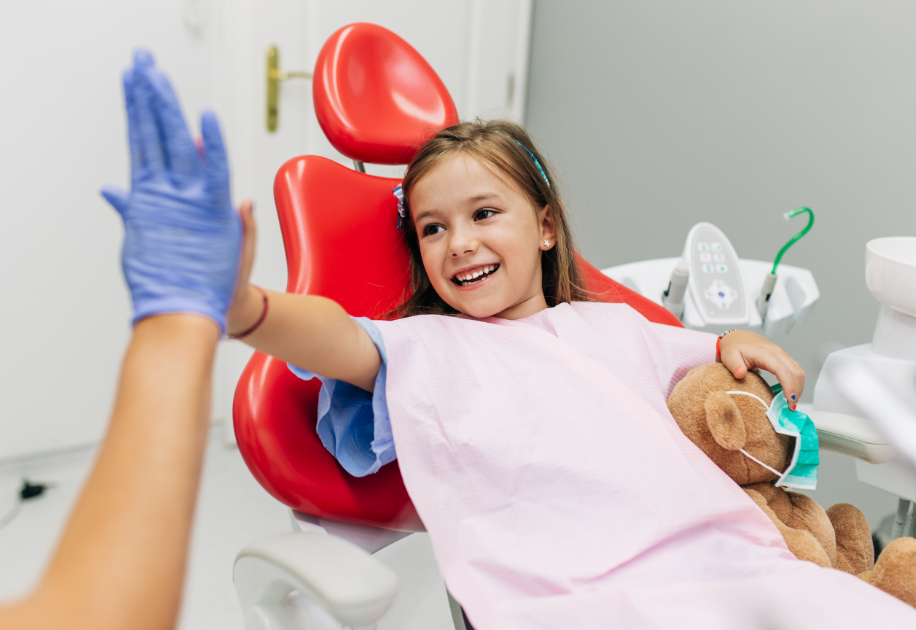 Child high-fiving dentist