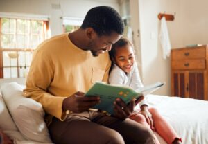 Parent and child reading a book about the dentist